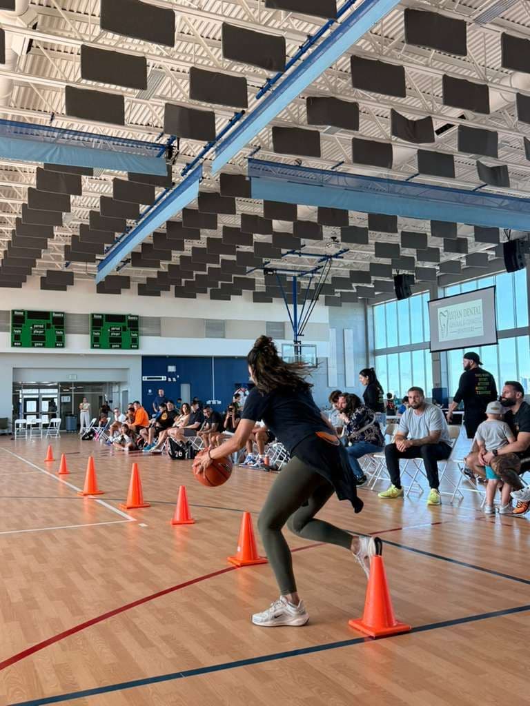 A coach running a cone dribbling drill
