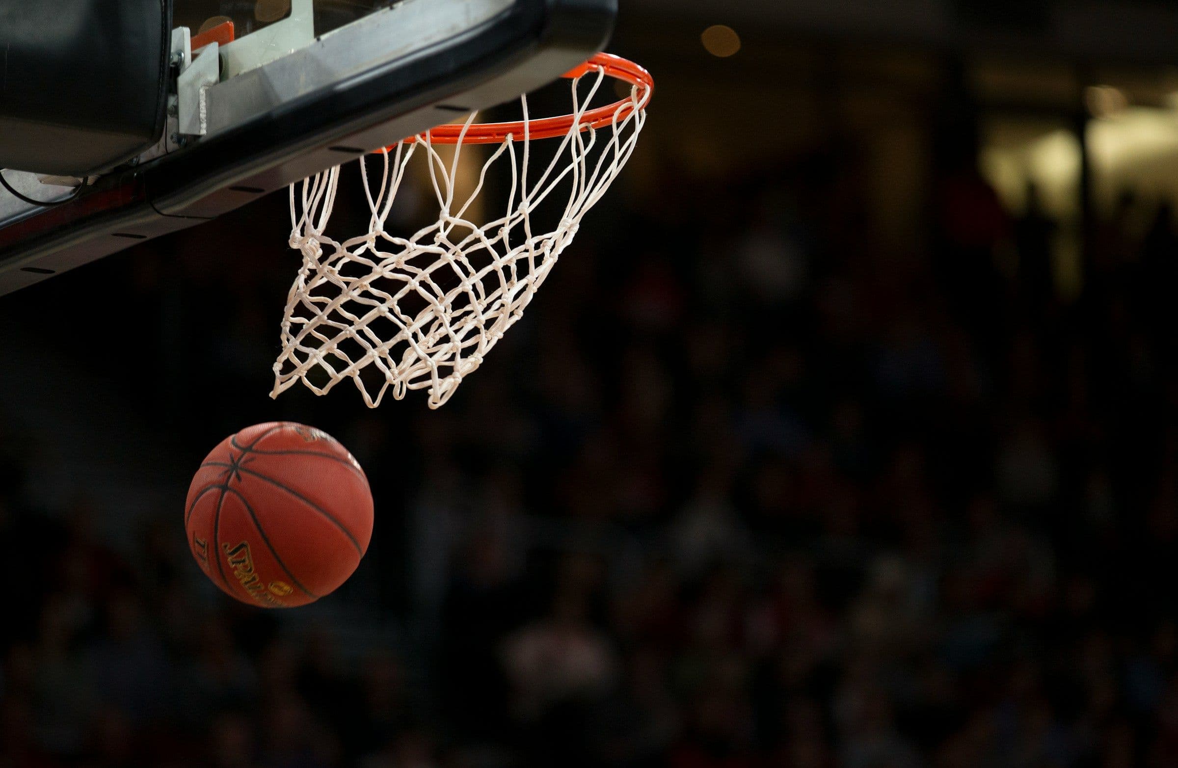 A basketball dropping through the net